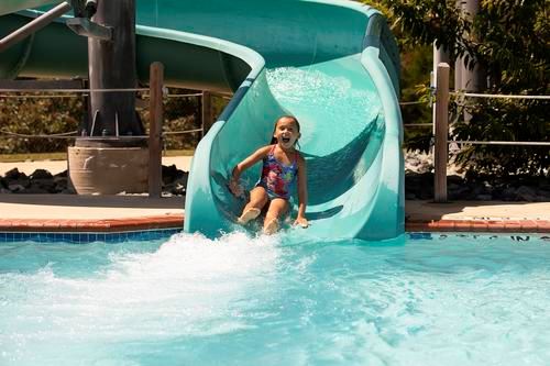 Girl on waterslide at Cove Point Pool