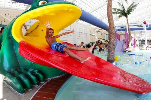 Boy on frog waterslide at Hall Aquatic Center