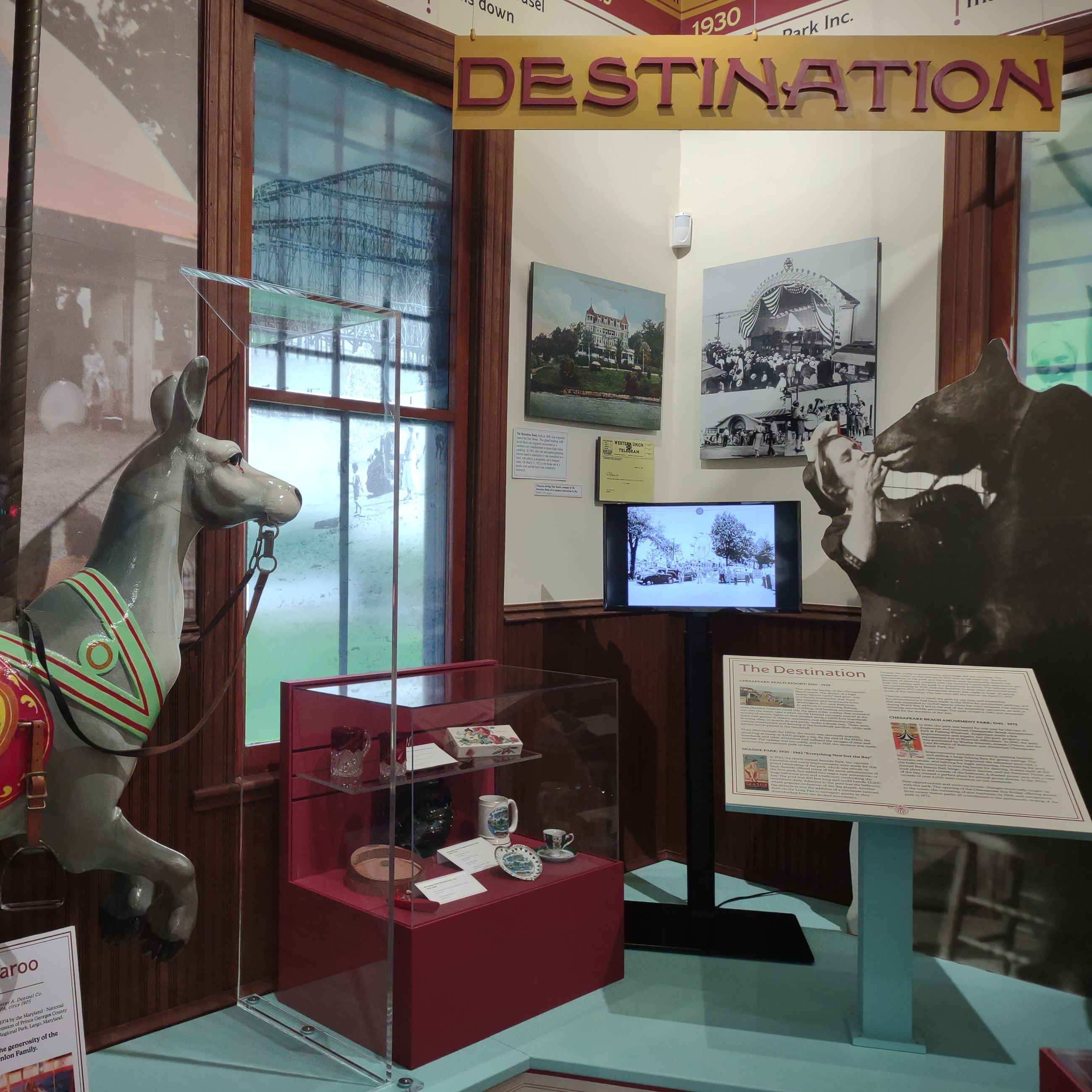 Exhibit at the Railway Museum with a kangaroo from the carousel, cardboard cutouts and signage