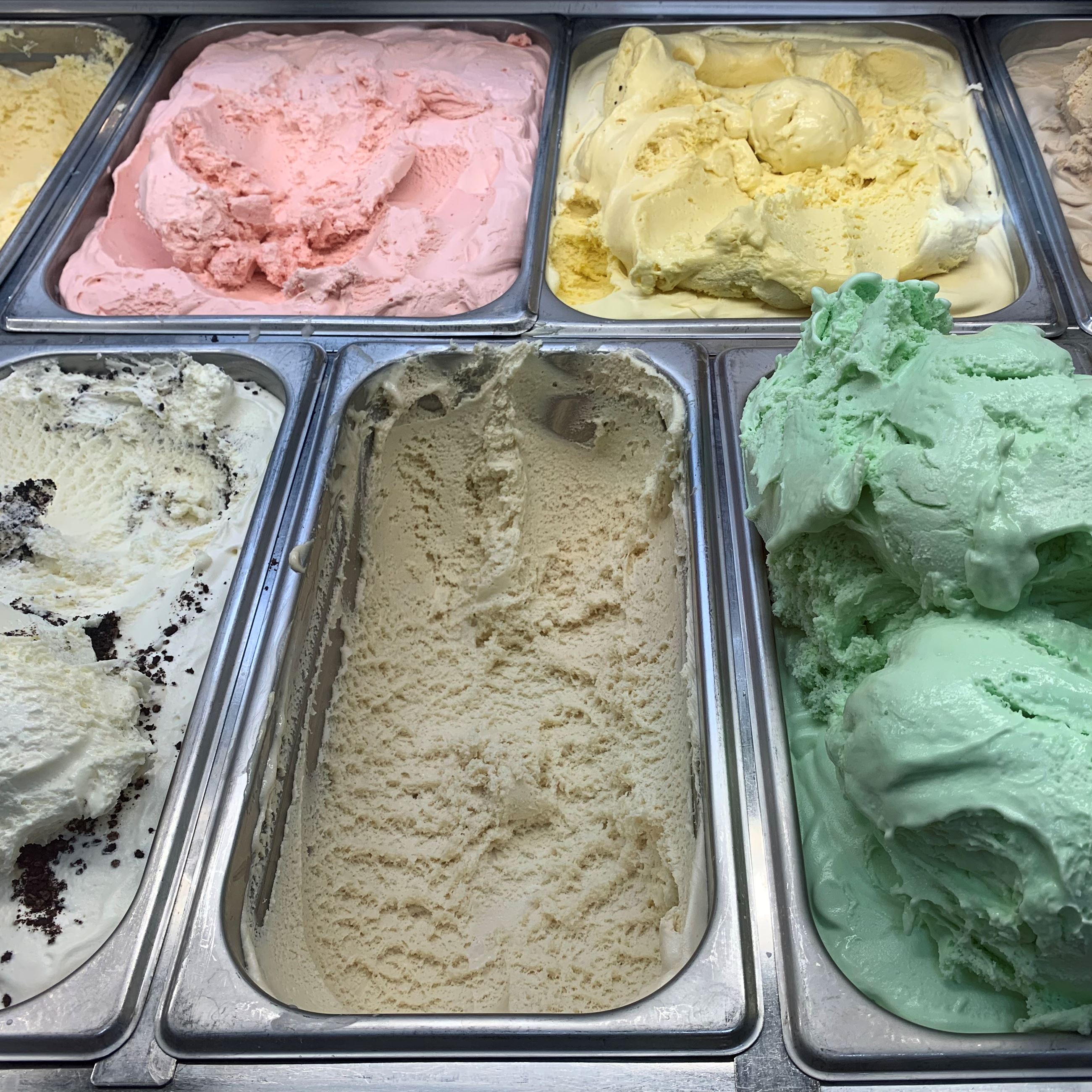 Variety of ice cream flavor tubs in the freezer