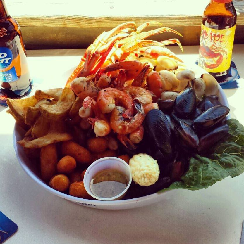 Seafood platter with clams, shrimp, crab, corn and beer