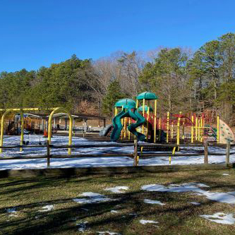 Solomons Town Center Park playground equipment with snow on the ground