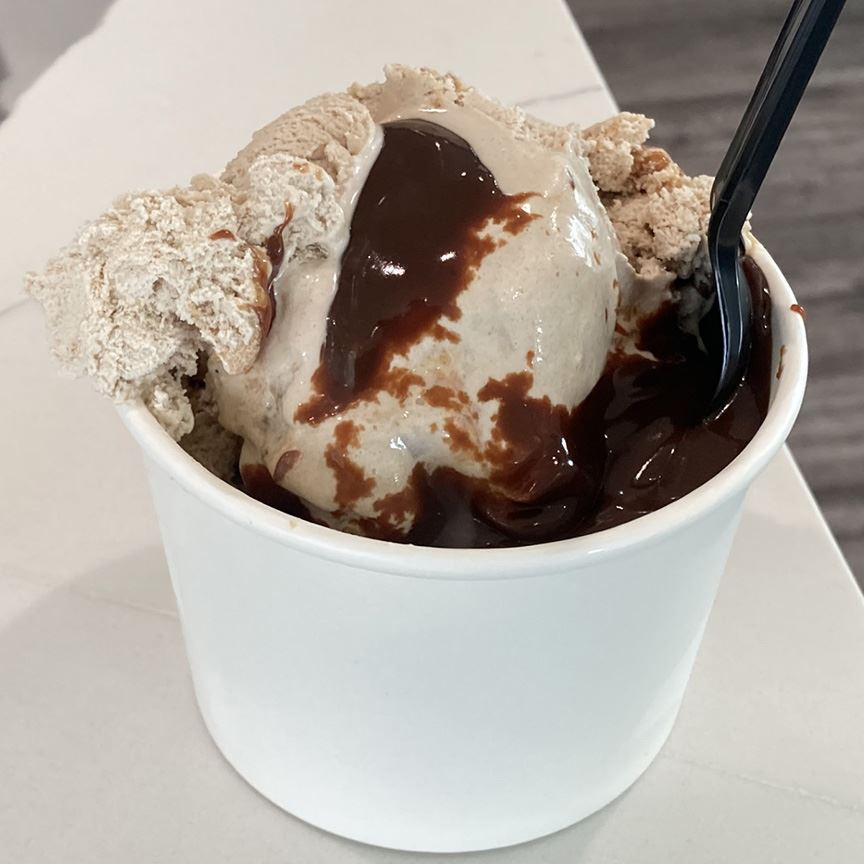 Chocolate ice cream cup with chocolate fudge and a spoon