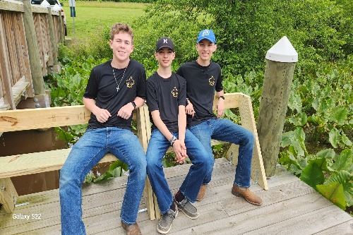 Three Eagles Scouts with benches they built