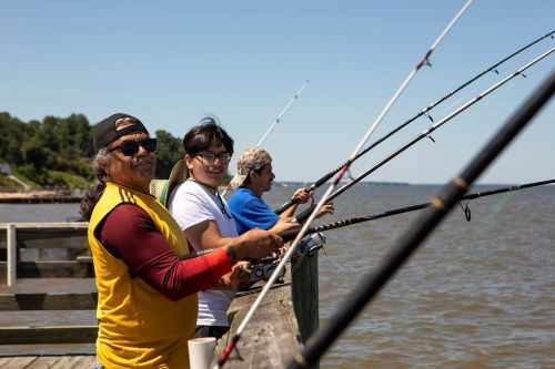 People fishing off pier